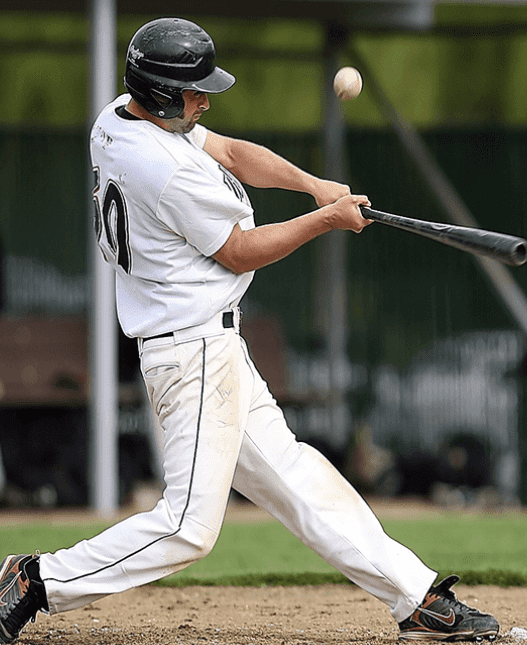 A baseball player swinging at a ball